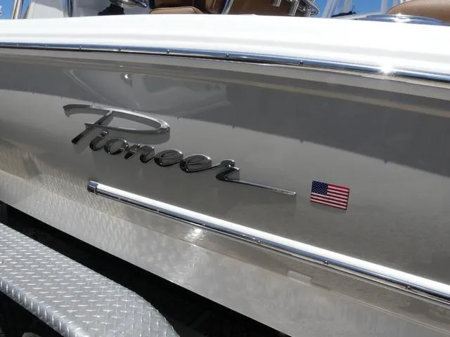 Slide: The Image of 2025 Pioneer ISLANDER 202 boat with American flag emblem on the side. - 3