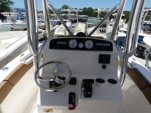 Slide: The Image of 2025 Pioneer ISLANDER 202 boat dashboard with steering wheel and gauges. - 6