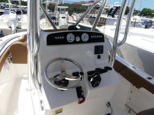 Slide: The Image of 2025 Pioneer ISLANDER 202 boat dashboard with steering wheel and controls. - 7