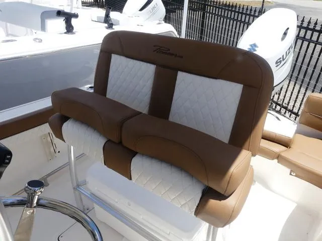 Slide: The Image of 2025 Pioneer ISLANDER 202 boat seat with brown and white upholstery. - 8