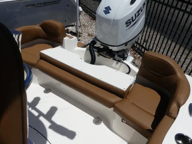 Slide: The Image of 2025 Pioneer ISLANDER 202 boat with Suzuki outboard motor and brown seating. - 9