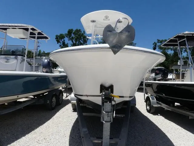 Slide: The Image of 2017 Sea Fox 246 Commander boat on trailer, surrounded by other boats, under clear blue sky. - 2