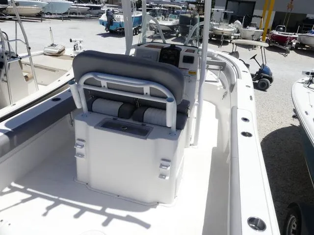Slide: The Image of 2017 Sea Fox 246 Commander boat interior with seating and console, docked among other boats. - 7