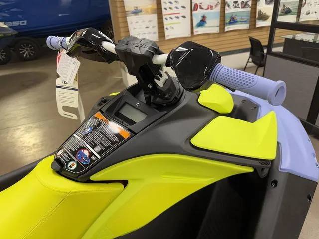 Slide: The Image of 2024 Sea-Doo Spark Trixx Waverunner in showroom, red and white design, on display. - 3