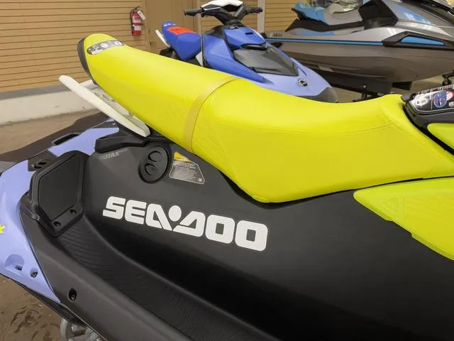 Slide: The Image of 2024 Sea-Doo Spark Trixx Waverunner in showroom, red and white design, Rotax 900 ACE engine. - 4
