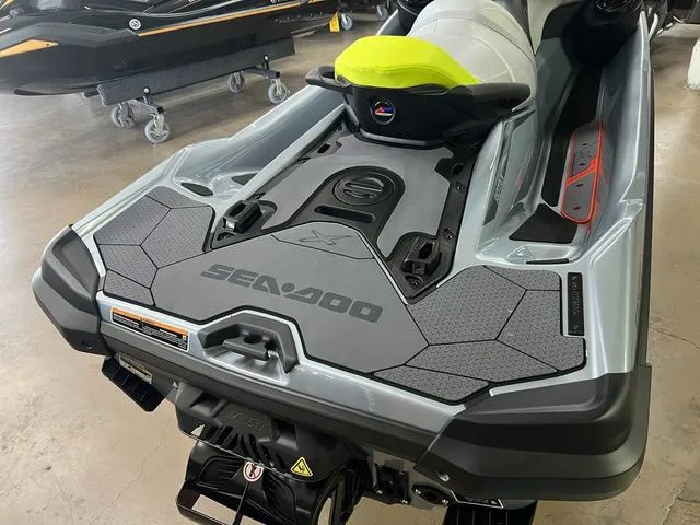 Slide: The Image of 2024 Sea-Doo Waverunner RXT, sleek design, gray and black color scheme, in showroom. - 7