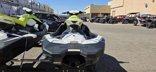 Slide: The Image of 2023 Sea-Doo Waverunner Spark 3-Up Rotax 900 ACE parked outdoors. - 3