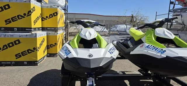 Slide: The Image of 2023 Sea-Doo Waverunner Spark 3-Up Rotax 900 ACE jet skis displayed outdoors. - 5