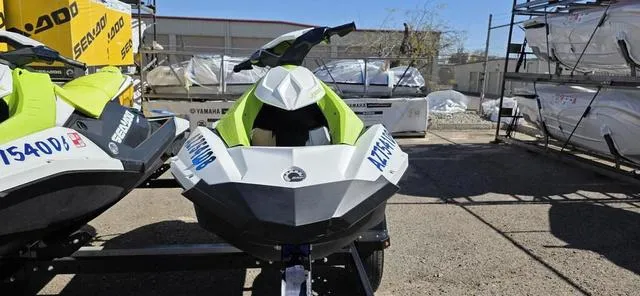 Slide: The Image of 2023 Sea-Doo Waverunner Spark 3-Up Rotax 900 ACE in a storage area. - 3