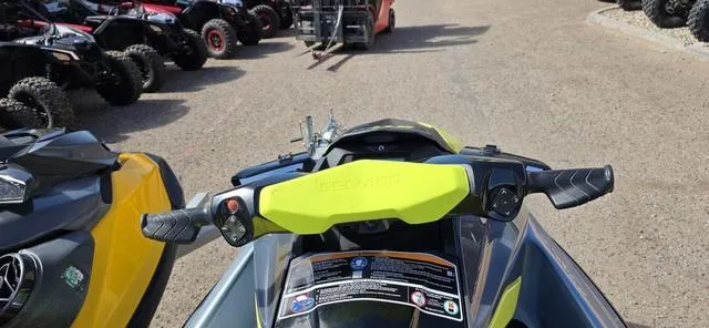 Slide: The Image of 2022 Sea-Doo Waverunner GTI SE 130 iBR handlebars, parked among other vehicles. - 3