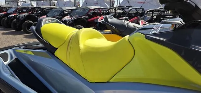 Slide: The Image of 2022 Sea-Doo Waverunner GTI SE 130 iBR with vibrant yellow seat, parked among other vehicles. - 4