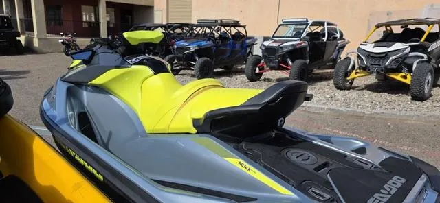 Slide: The Image of 2022 Sea-Doo Waverunner GTI SE 130 iBR in a parking lot with off-road vehicles. - 5