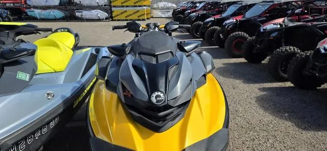 Slide: The Image of 2021 Sea-Doo RXP-X 300 in Millennium Yellow, parked among other vehicles. - 3