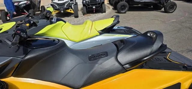 Slide: The Image of 2021 Sea-Doo RXP-X 300 Waverunner in Millennium Yellow, parked with other vehicles. - 6