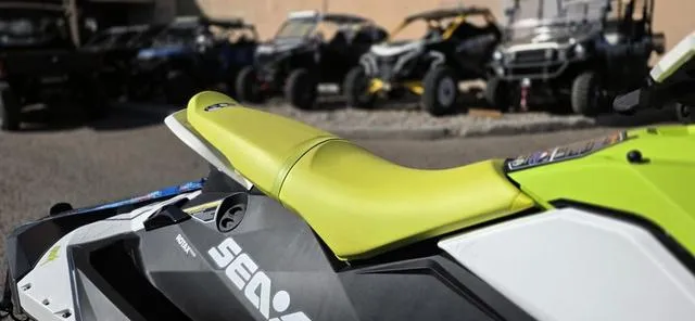 Slide: The Image of 2023 Sea-Doo Spark 3-Up Rotax 900 ACE with IBR, lime green seat, parked outdoors. - 4