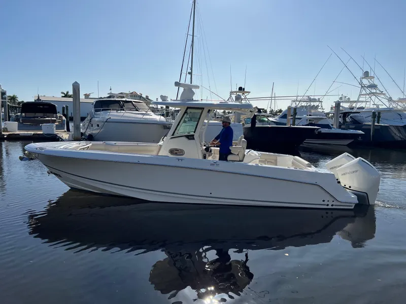 Slide: The Image of 2020 Boston Whaler 280 Outrage boat docked in a marina under clear skies. - 12