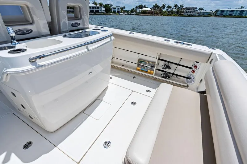 Slide: The Image of 2020 Boston Whaler 280 Outrage boat interior with seating and storage, near waterfront homes. - 20