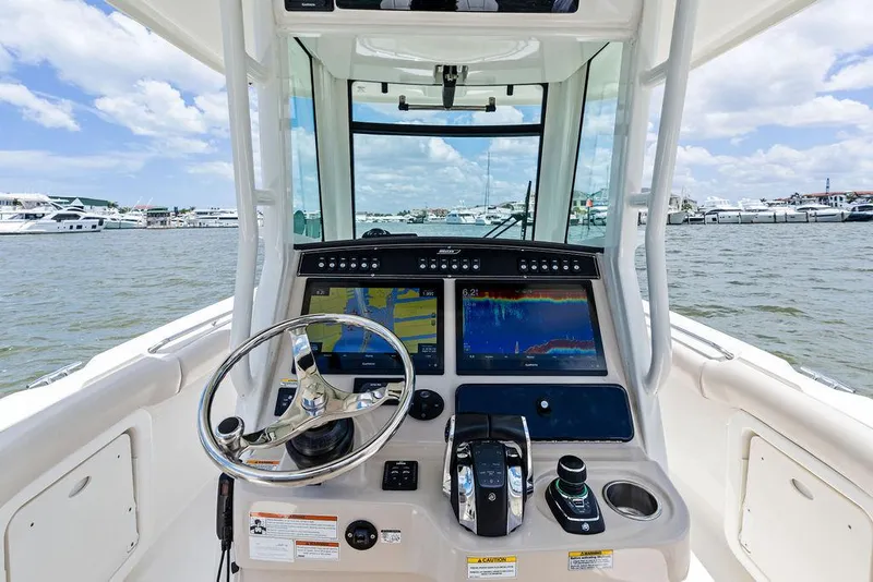 Slide: The Image of Boston Whaler 280 Outrage 2020 helm with advanced navigation system on open water. - 21