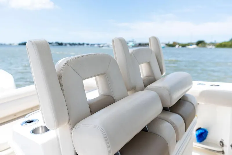 Slide: The Image of 2020 Boston Whaler 280 Outrage boat seats with ocean view in background. - 24