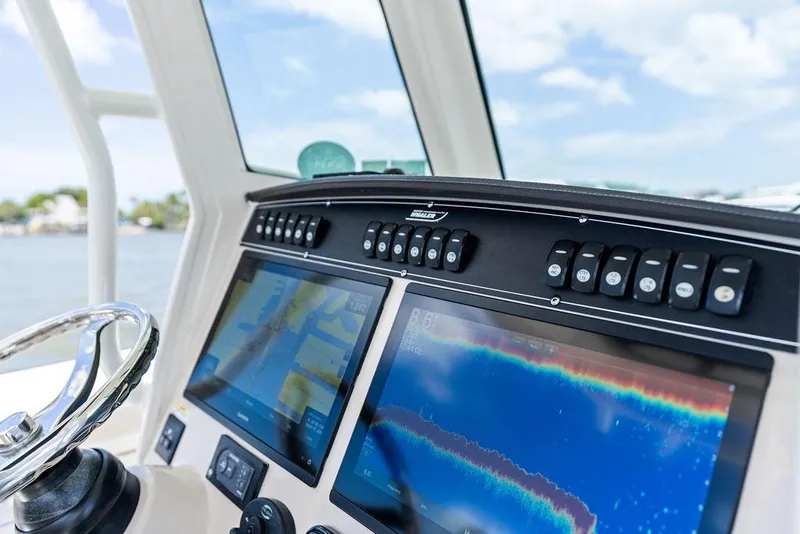 Slide: The Image of Control panel of 2020 Boston Whaler 280 Outrage with navigation screens and buttons. - 25
