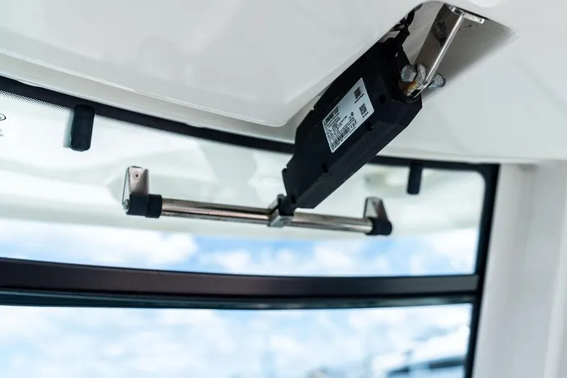Slide: The Image of Boston Whaler 280 Outrage 2020 boat interior detail with window mechanism. - 30