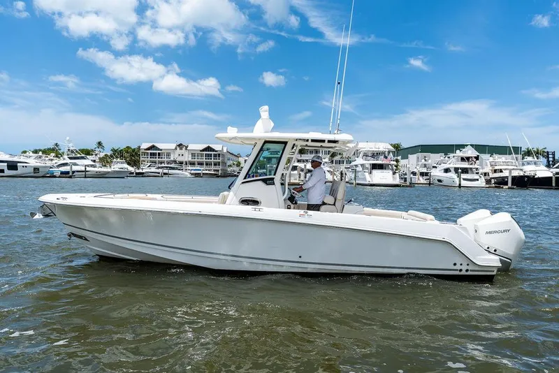 Slide: The Image of 2020 Boston Whaler 280 Outrage boat cruising on a sunny day near a marina. - 7