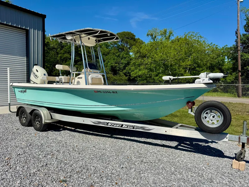 Slide: The Image of 2018 Bulls Bay 2200 boat on trailer, parked outdoors near a garage. - 1