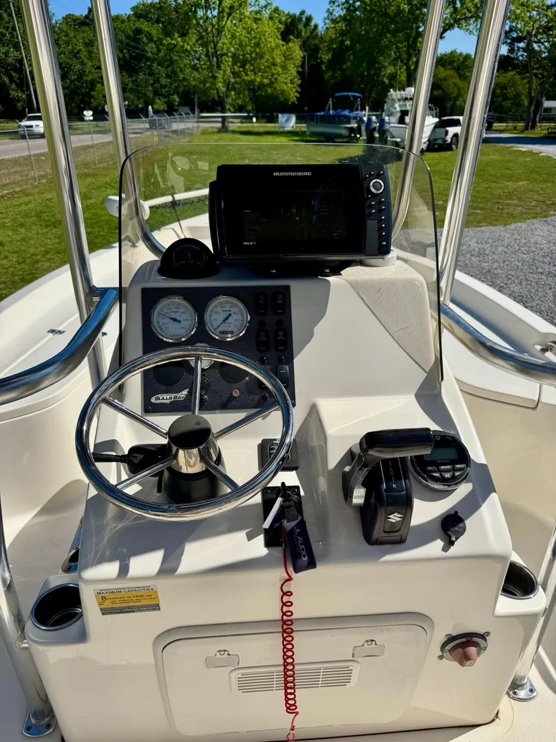 Slide: The Image of 2018 Bulls Bay 2200 boat console with steering wheel and navigation equipment. - 11
