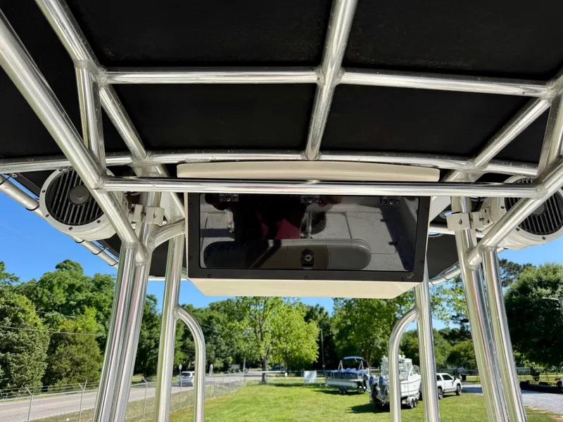 Slide: The Image of 2018 Bulls Bay 2200 boat T-top frame with speakers, set against a green landscape. - 12