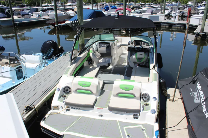 The Image of 2017 Chaparral Vortex 2430 VRX boat docked at marina, featuring spacious seating and modern design. - 1