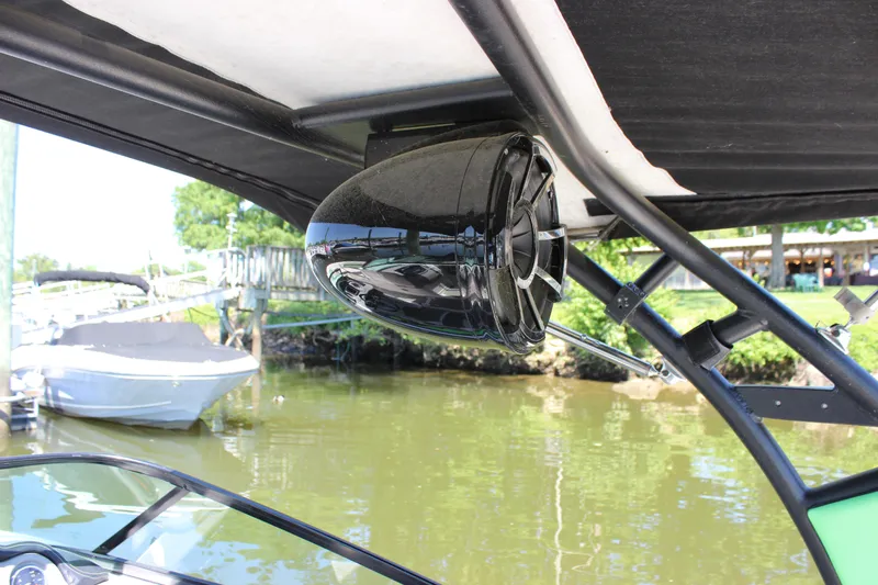 Slide: The Image of 2017 Chaparral Vortex 2430 VRX boat speaker under canopy by the water. - 12