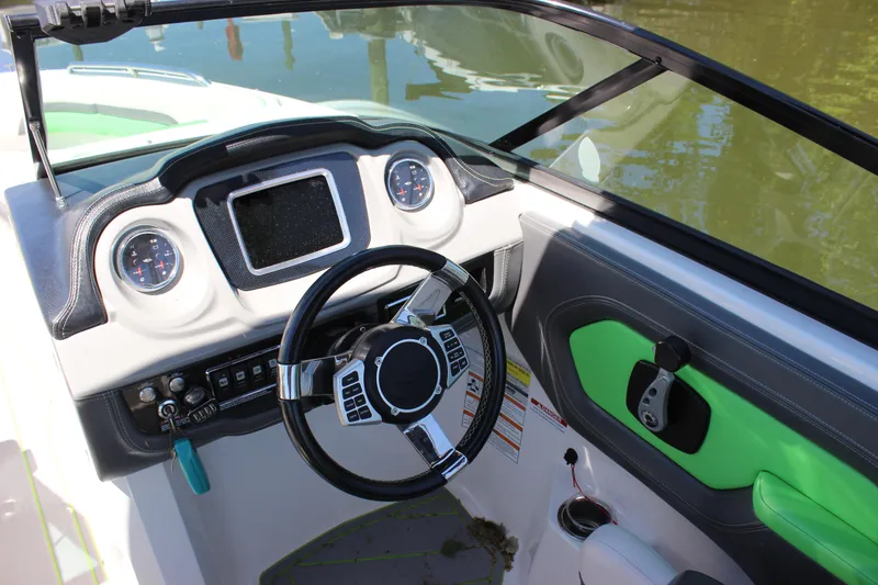 Slide: The Image of 2017 Chaparral Vortex 2430 VRX boat dashboard with steering wheel and gauges. - 13