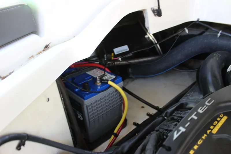 Slide: The Image of Battery compartment of 2017 Chaparral Vortex 2430 VRX boat, showing wiring and engine components. - 20