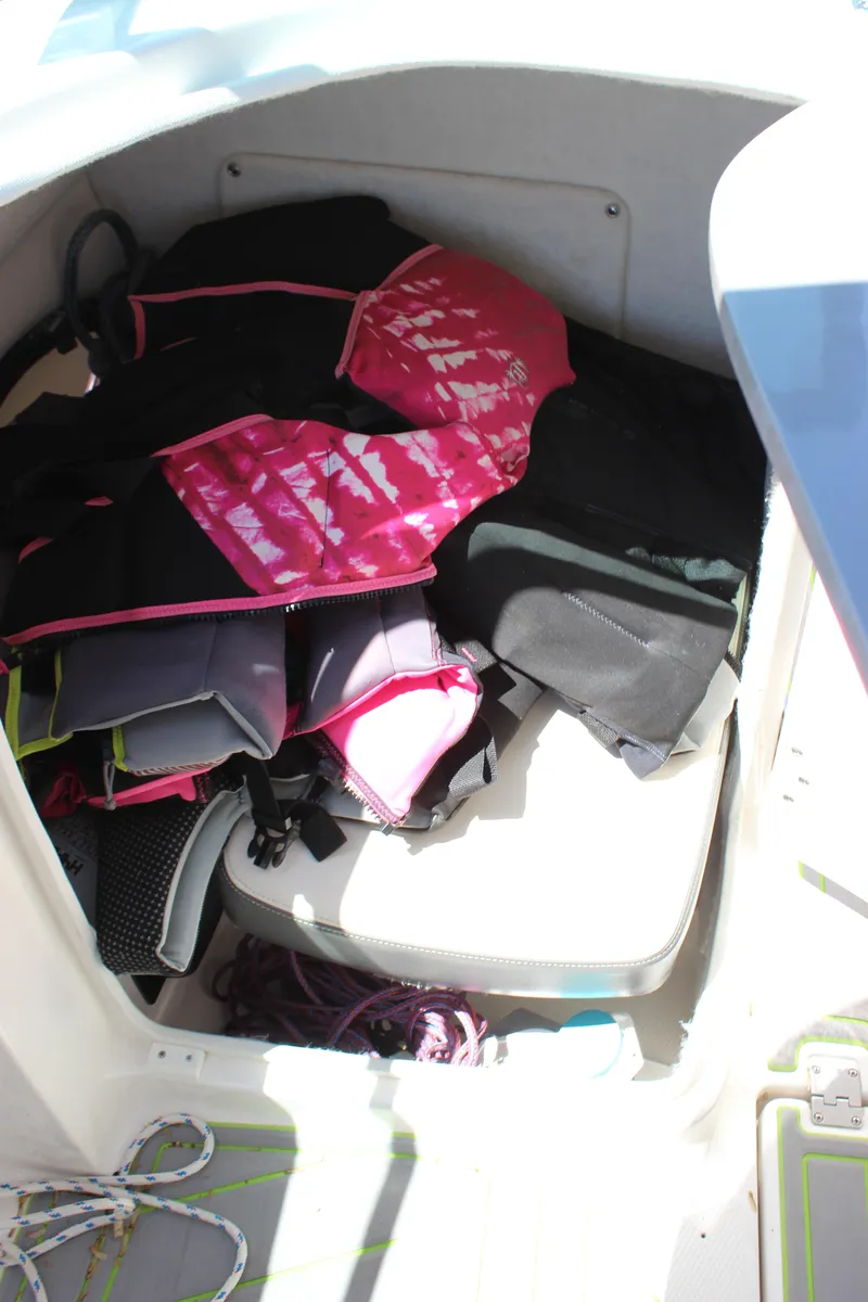 Slide: The Image of Life jackets stored in a 2017 Chaparral Vortex 2430 VRX boat compartment. - 22