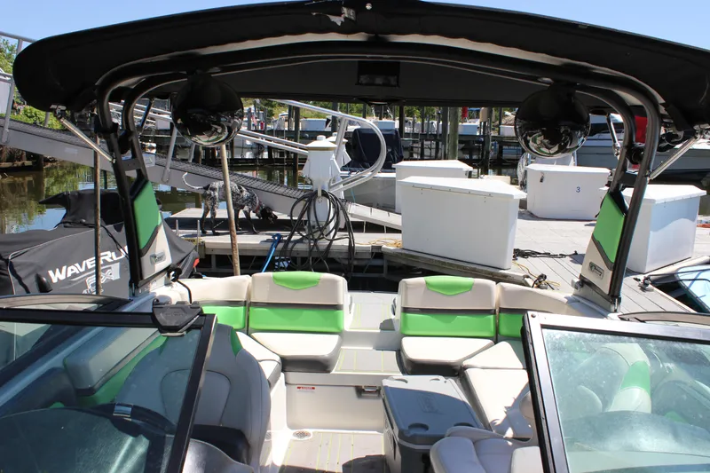 Slide: The Image of 2017 Chaparral Vortex 2430 VRX boat interior with green accents at a marina. - 27