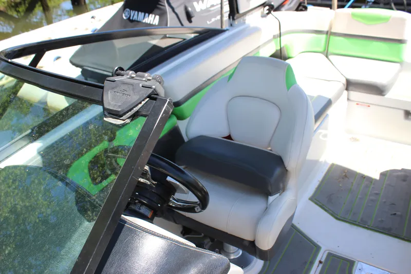 Slide: The Image of 2017 Chaparral Vortex 2430 VRX boat interior with green accents and steering wheel. - 28