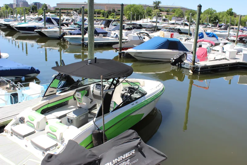 Slide: The Image of 2017 Chaparral Vortex 2430 VRX boat docked in a marina with other vessels. - 32