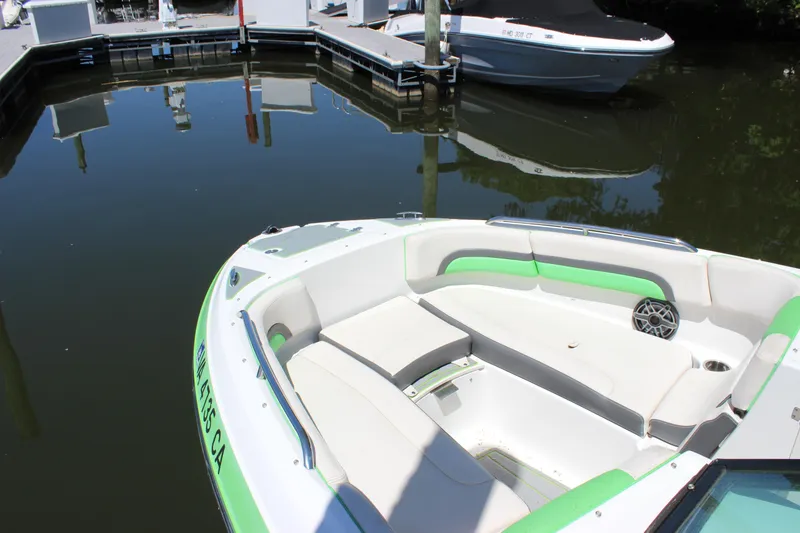 Slide: The Image of 2017 Chaparral Vortex 2430 VRX boat docked, featuring spacious seating and sleek design. - 6