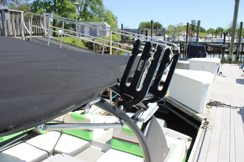 Slide: The Image of 2017 Chaparral Vortex 2430 VRX boat with black cover and wakeboard rack at dock. - 8
