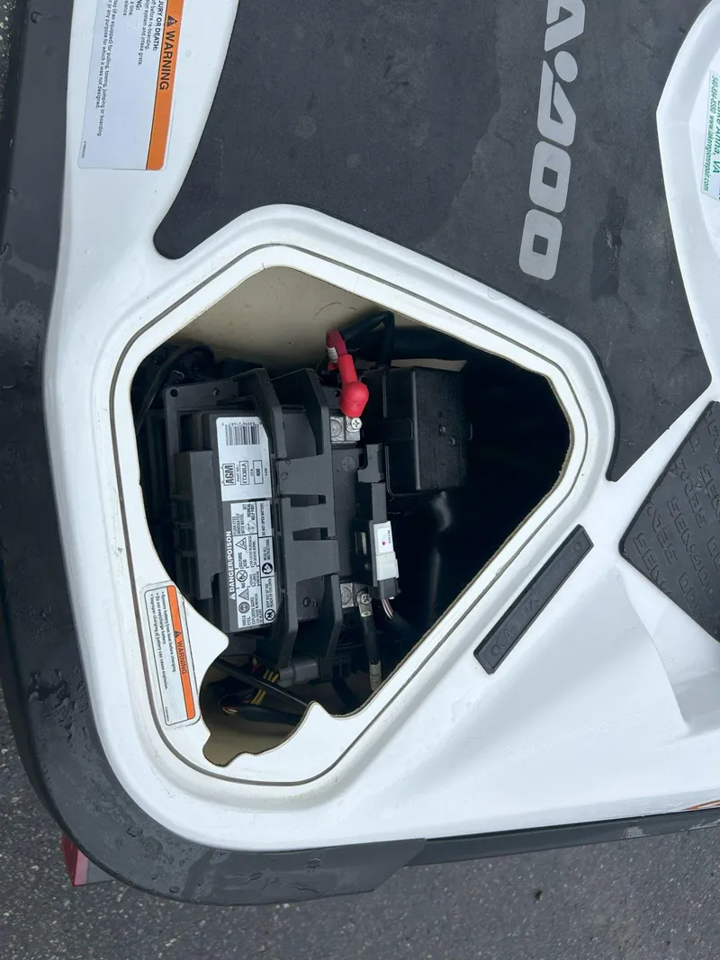 Slide: The Image of 2015 Sea-Doo GTX 155 battery compartment with visible wiring and labels. - 12