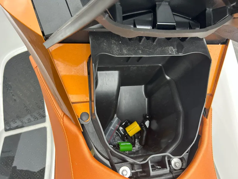Slide: The Image of Open storage compartment of 2015 Sea-Doo GTX 155 with small items inside. - 15