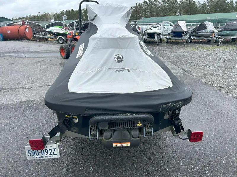 Slide: The Image of 2015 Sea-Doo GTX 155 covered on trailer, parked in outdoor lot. - 16