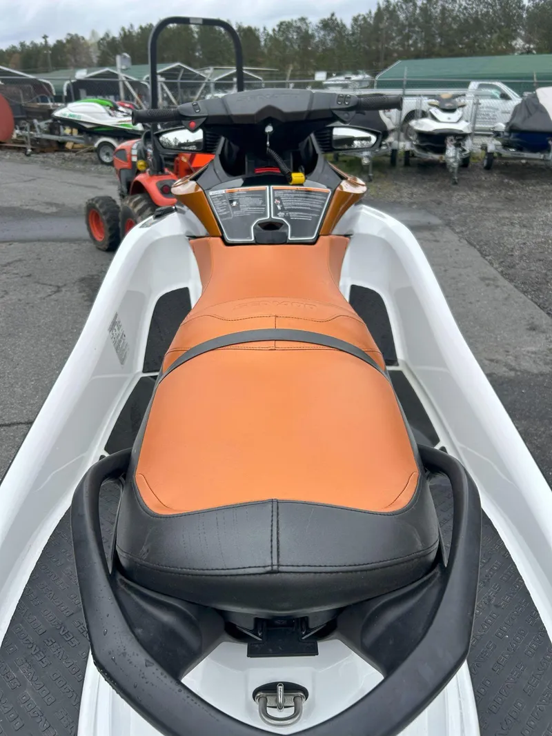 Slide: The Image of 2015 Sea-Doo GTX 155 jet ski with orange seat, parked outdoors. - 19