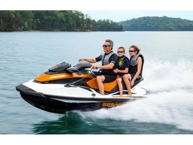 Slide: The Image of 2015 Sea-Doo GTX 155 jet ski with three riders on a lake. - 32