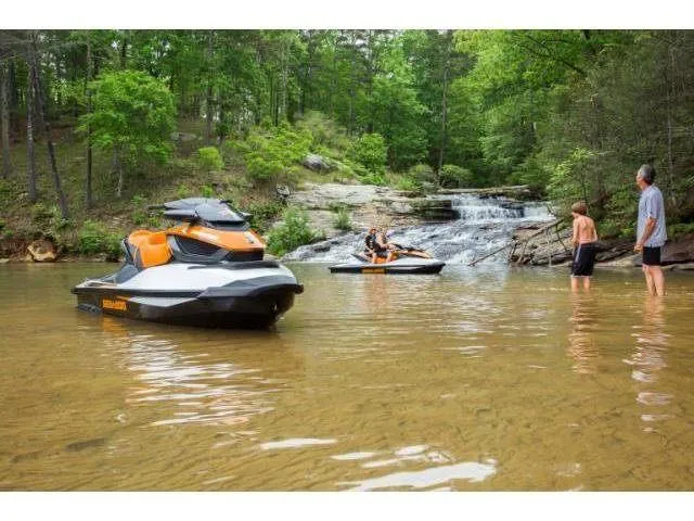 Slide: The Image of 2015 Sea-Doo GTX 155 jet skis on a scenic river with waterfall and people nearby. - 33
