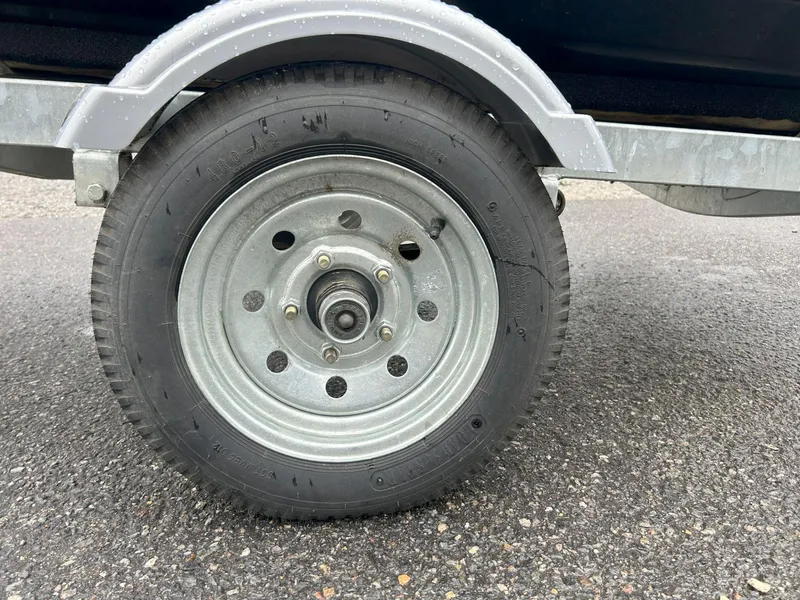 Slide: The Image of Trailer wheel for 2015 Sea-Doo GTX 155 on asphalt surface. - 6