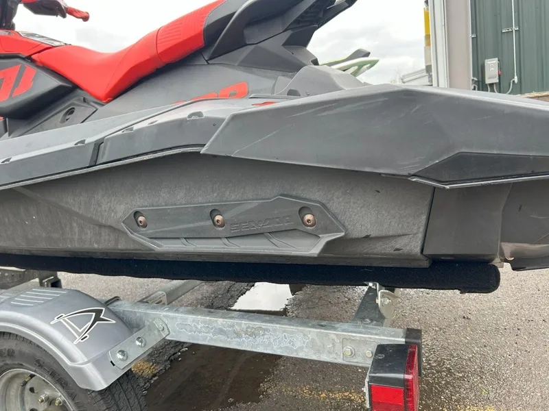 Slide: The Image of 2021 Sea-Doo Spark Trixx 3up iBR on trailer, showcasing sleek design and vibrant red seat. - 10