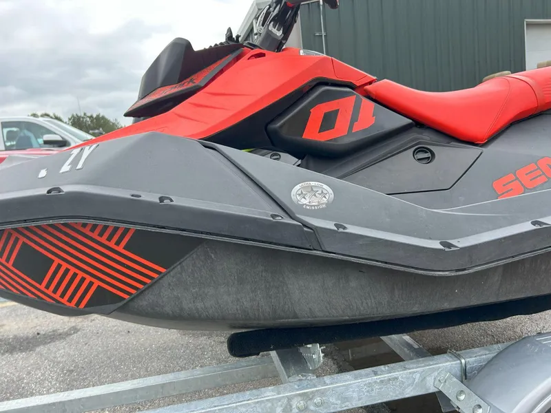Slide: The Image of 2021 Sea-Doo Spark Trixx 3up iBR with sound system, red and black design. - 11