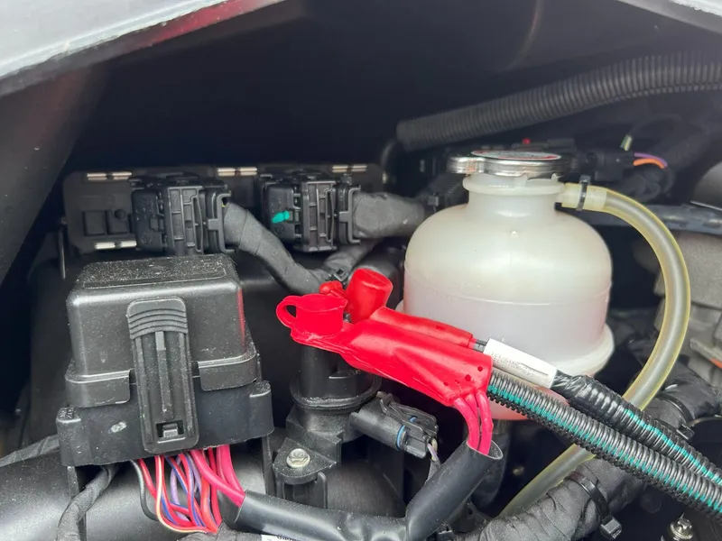 Slide: The Image of Engine compartment of a 2021 Sea-Doo Spark Trixx 3up iBR with visible wiring and components. - 12