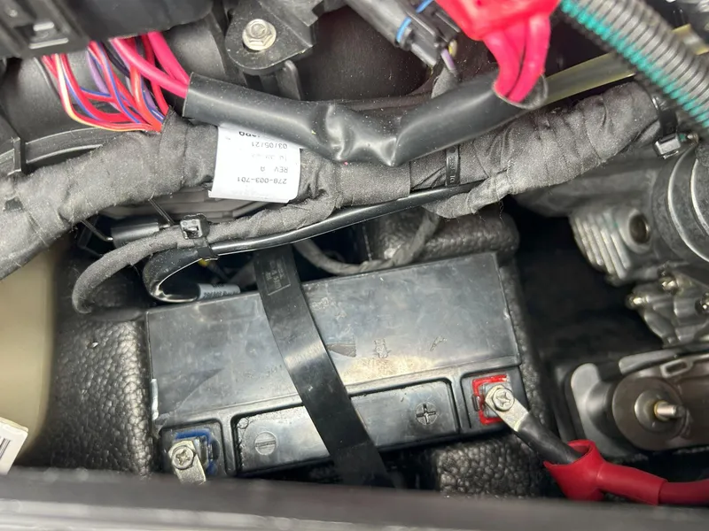 Slide: The Image of 2021 Sea-Doo Spark Trixx 3up iBR battery compartment with wiring and connections. - 13